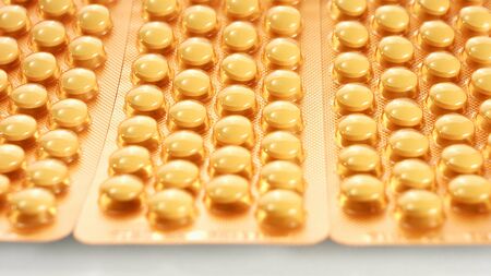 Yellow pills medical backgroundの写真素材