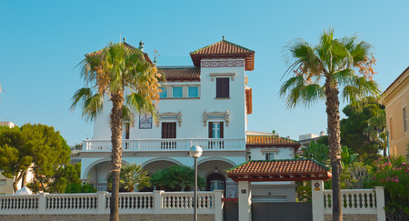 Beautiful Spanish house with palm trees, sunny summer day, Salou Cityのeditorial素材