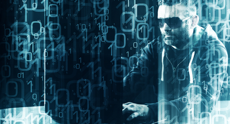 Hacker typing on laptop computer keyboard binary code backgroundの写真素材