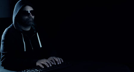 Programmer hacker typing on keyboard