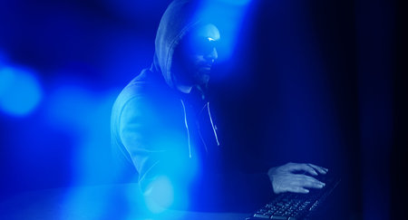 Night hacker hacking on computer keyboard