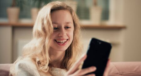Teenager girl taking photograph using mobile phoneの写真素材