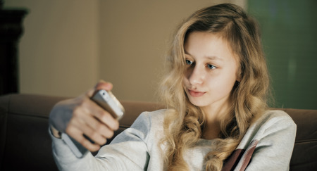 Cute blond hair girl takes selfieの写真素材