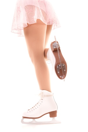 woman legs in white ice skatesの写真素材