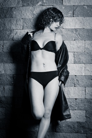 young beautiful woman in underwear and a raincoatの写真素材