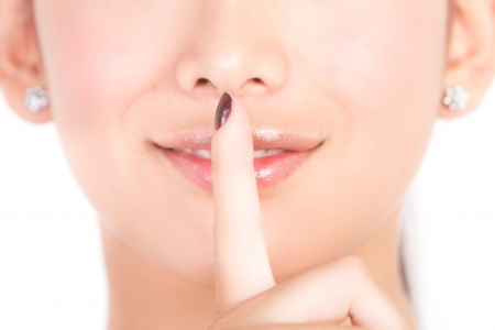 Mouth, of young beautiful brunette with fingerの写真素材