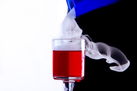 drink in glass with smoke pouring on topの写真素材
