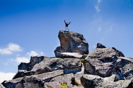 Young backpacker standing on top of a mountainの写真素材