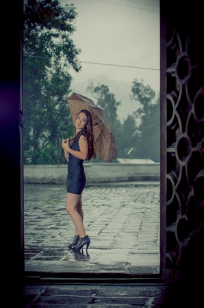 Woman with umbrella in the rainの写真素材