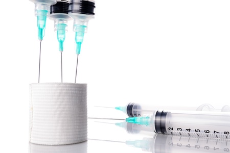 hypodermic needle and gauze, white backgroundの写真素材