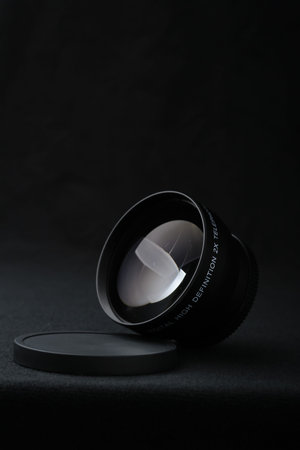 Camera lens close up on black background