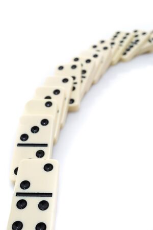 Fallen dominoes over white backgroundの写真素材