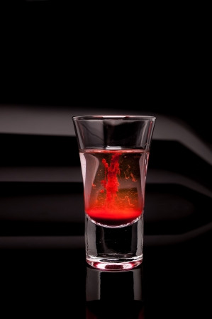red shot glass on a dark backgroundの写真素材