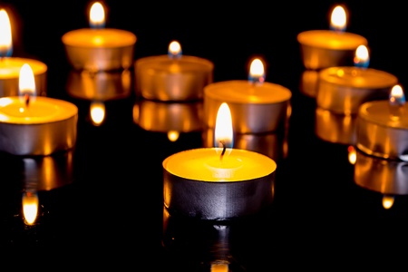 Group of burning candles on  black background の写真素材