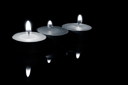 row of  three candles, in black and white の写真素材