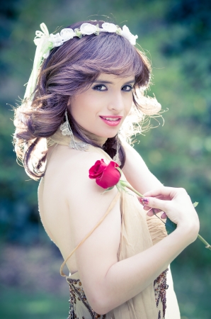 portrait of attractive smiling woman with a roseの写真素材