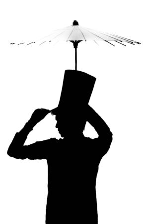 Silhouette of a man in a hat with an umbrella  の写真素材
