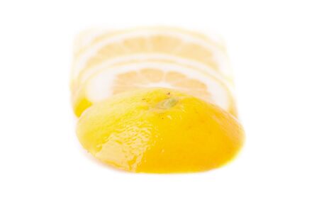 yellow Lemons and slice on a white backgroundの写真素材