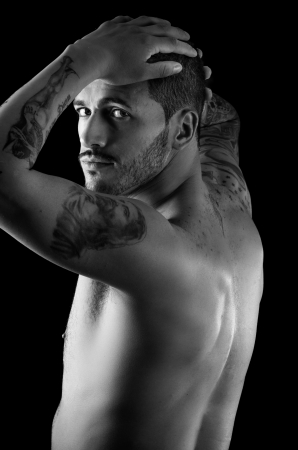Muscular young man with many tattoosの写真素材