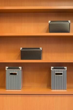 wooden bookshelf with boxesの写真素材