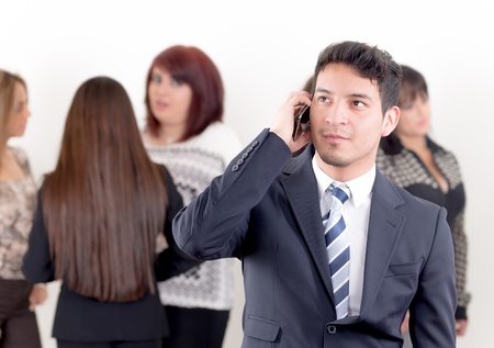 Hispanic man using a cellphone in the officeの写真素材