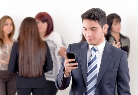 Hispanic man using a cellphone in the officeの写真素材