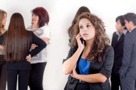 Hispanic woman using a cellphone with peersの写真素材
