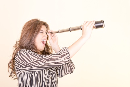 Young woman using telescopeの写真素材