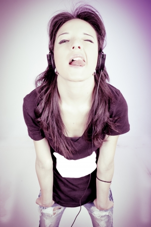 Young beautiful girl happy listening to musicの写真素材