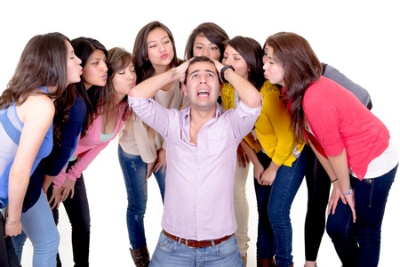 Eight Girls kissing a stressed manの写真素材