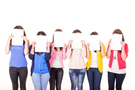 Women hiding their faces behind blank signsの写真素材