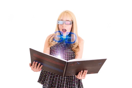 Smiling woman reading a book with 3d glasses conceptの写真素材