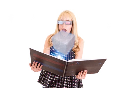 Smiling woman reading a book with 3d glasses conceptの写真素材
