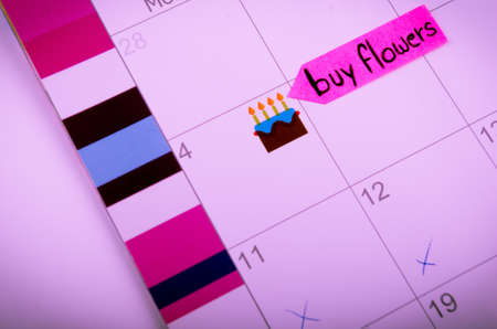 Calendar with a note to buy flowersの写真素材