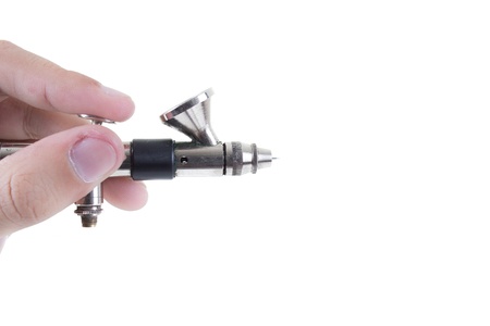 Airbrush in hand Isolated on white backgroundの写真素材