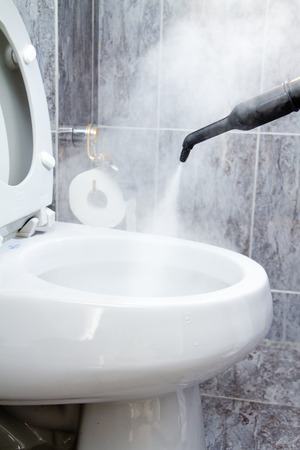 cleaning a toilet with steamの写真素材