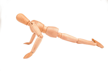 Jointed wooden mannequin doing push-ups isolated on white backgroundの写真素材