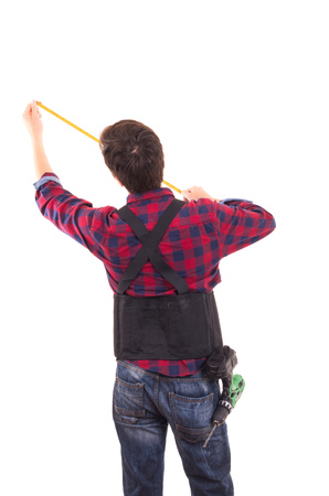 man with measuring tape handyman on white backgroundの写真素材