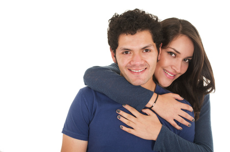 close-up hispanic young couple wearing blue clothes hugging isolated on whiteの写真素材