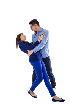 young attractive mand hugging and leaning towards girlfriend to kiss her isolated