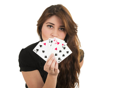 Beautiful young brunette girl holding deck of cards in her hand isolated on white