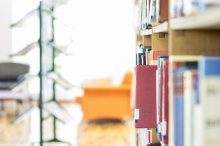 Red book in Public Library bookshelf ready to take out selective focus nobodyの写真素材