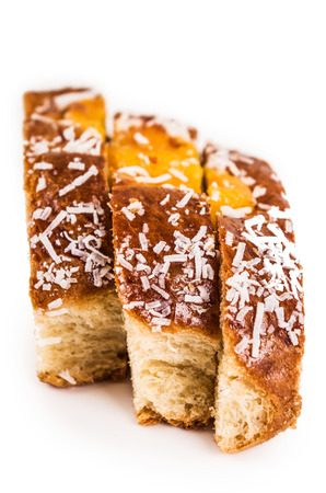 baked coconut sweet bun cut into slices isolated on whiteの写真素材