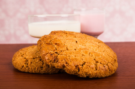 homemade cookies vanilla sugar oatmeal with glass of milk and milkshake on wodden table selective focusの写真素材