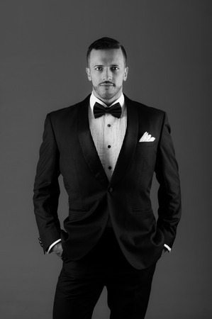 Handsome young latin man wearing a tuxedo black and white portrait