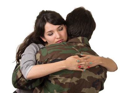 young woman and soldier in military uniform say goodbye deployment isolated on whiteの写真素材