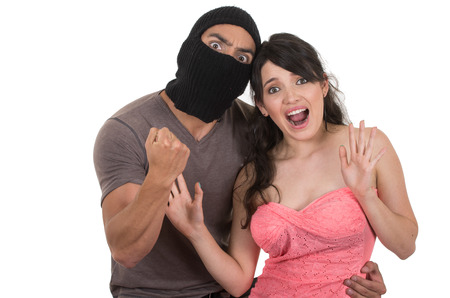 male masked thief holding young girl isolated on whiteの写真素材