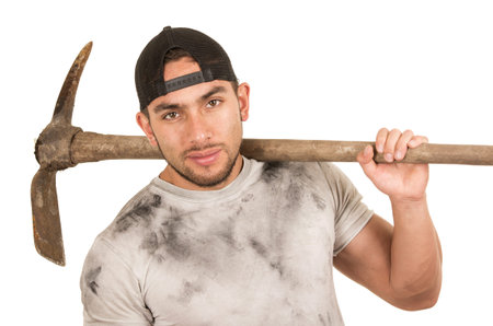 young muscular latin construction worker holding pickaxe isolated on white