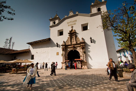 CUENCA, ECUADOR - AUGUST 23, 2010: Pedestrians walking in one of Cuenca's landmarks Plaza de las Flores, Cuenca, Ecuadorのeditorial素材