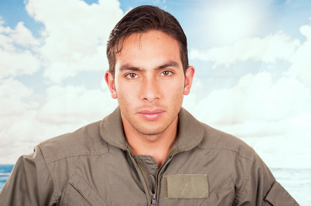 closeup portrait of handsome pilot with blue sky on the backgroundの写真素材
